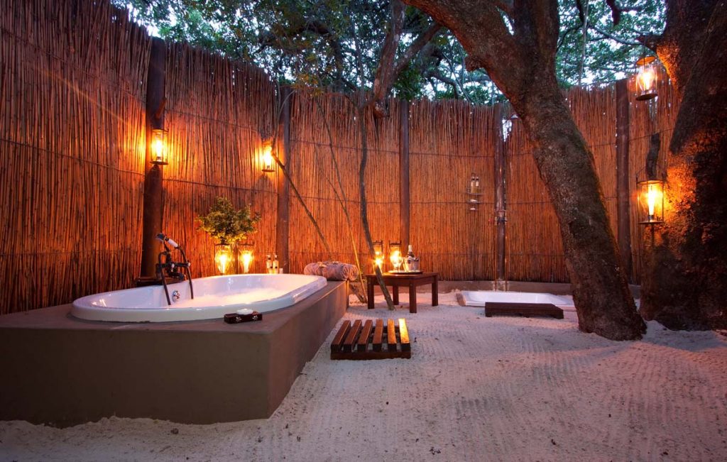 Openair bath tub in a sandy surface. 