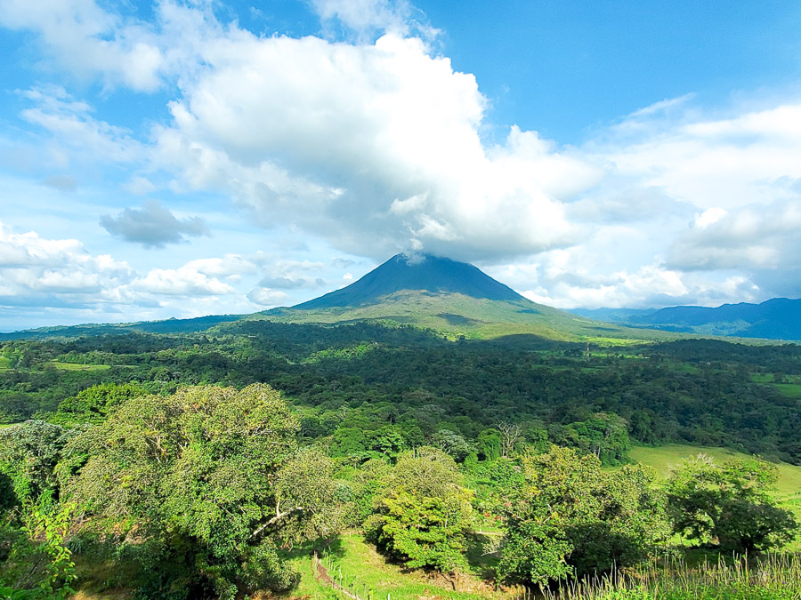 Arenal Volcano in the background rainforest in the front