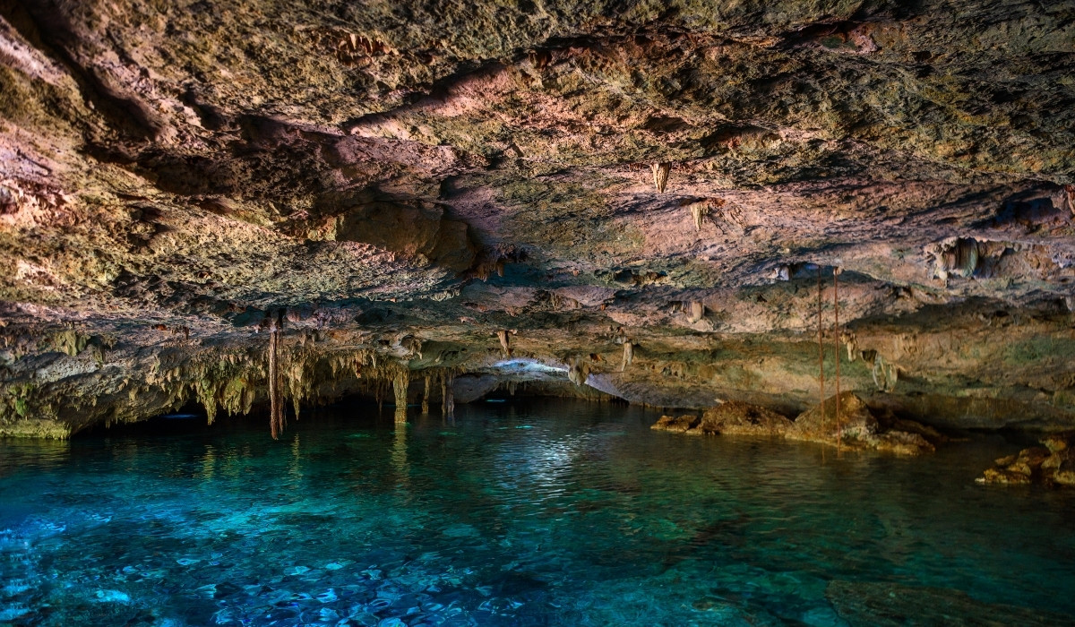 Cave with blue water in it.