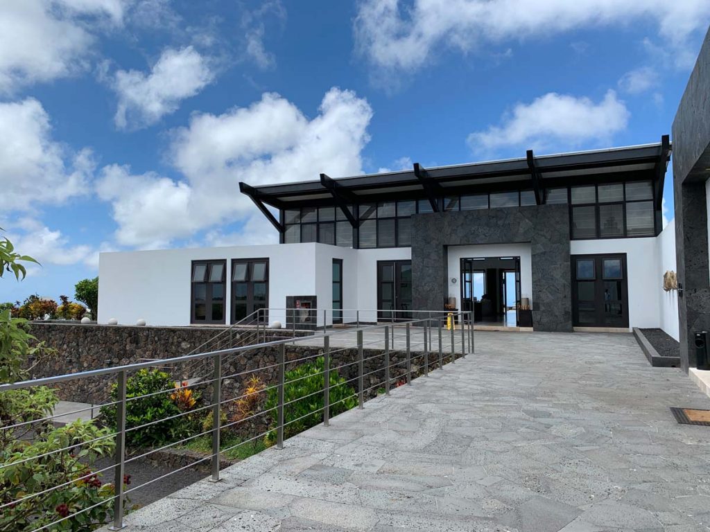 White and grey lodge made of stones and glass windows