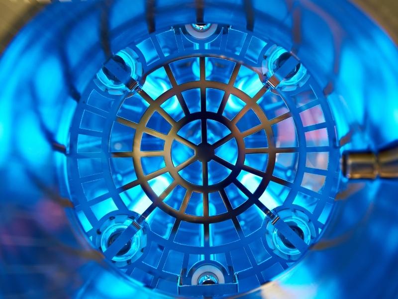 Vibrant blue light inside a metal tube.