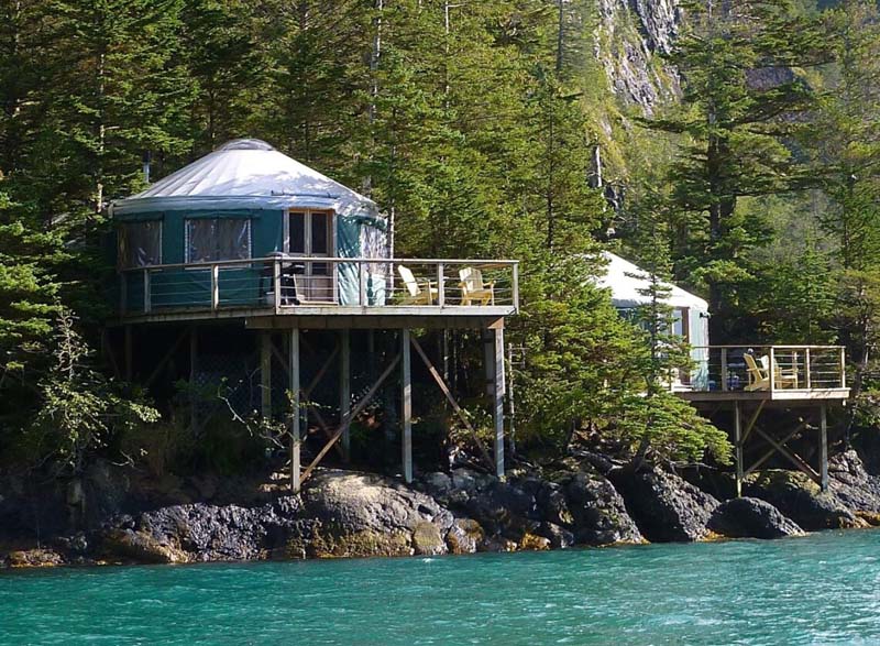 A yurt on the seaside at the foot of the hill.