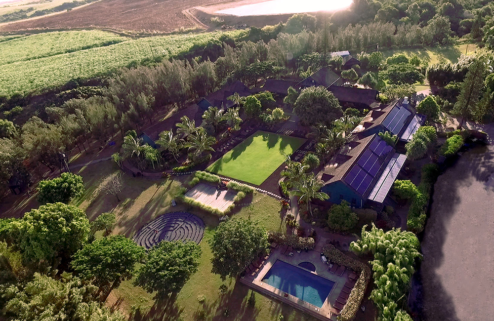 A resort from above with small buildings and a swimming pool.