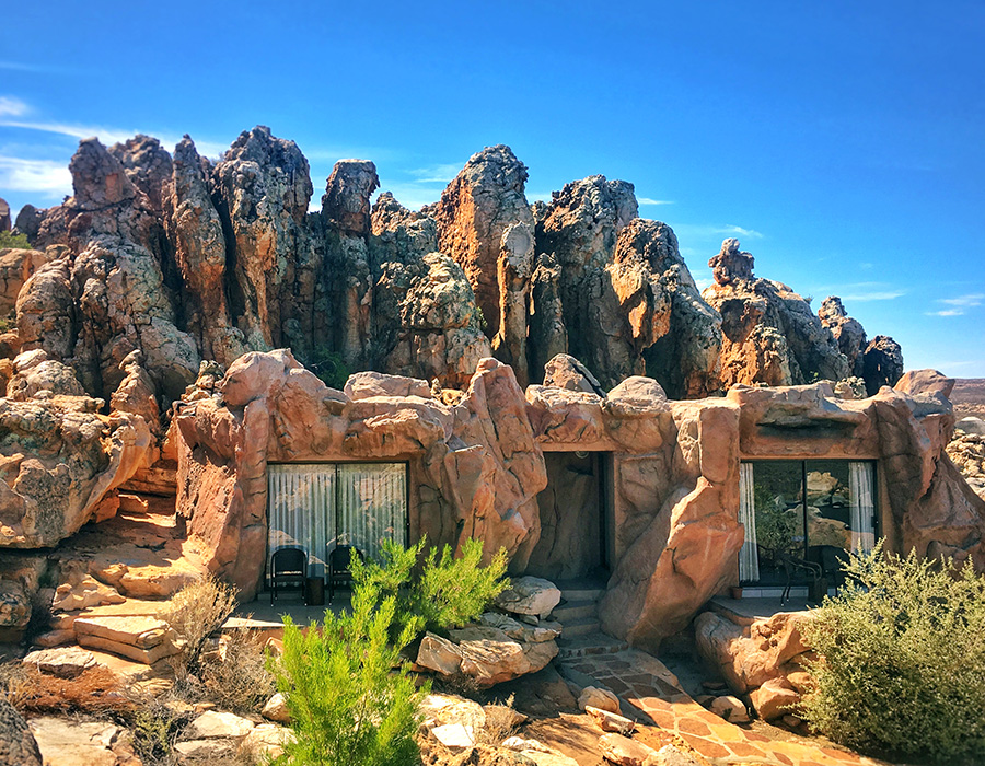 Small suites inside rock formations. Only the windows are visible. 