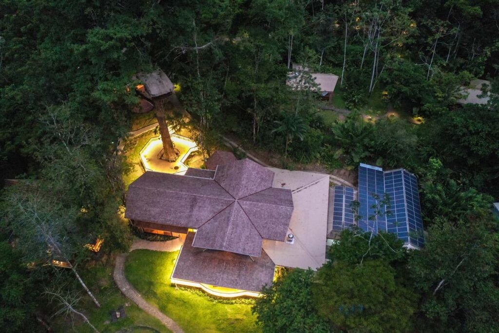 A lodge from above with solar panels and illuminated pavements. 
