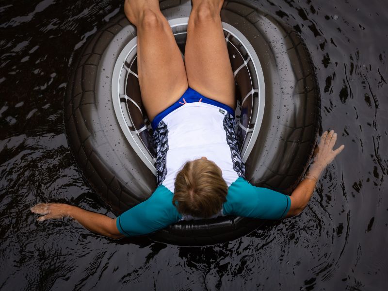 A woman is sitting on a swimming float/tube.