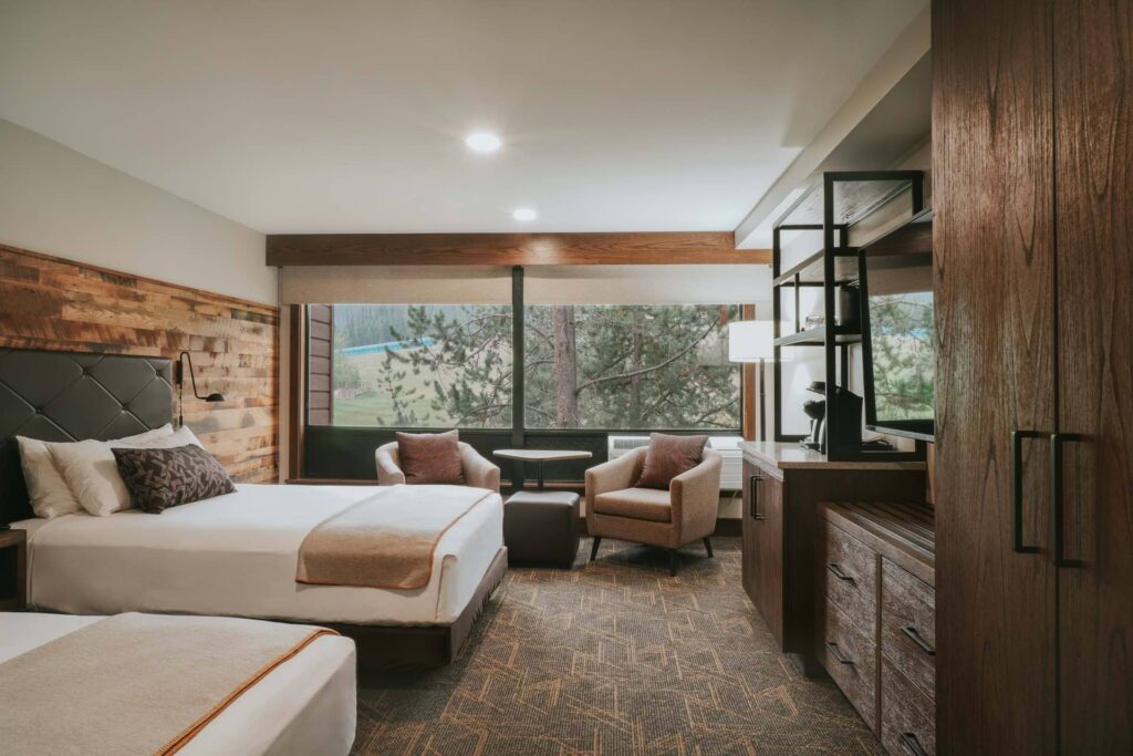 Luxury bedroom with a view on pine trees. 