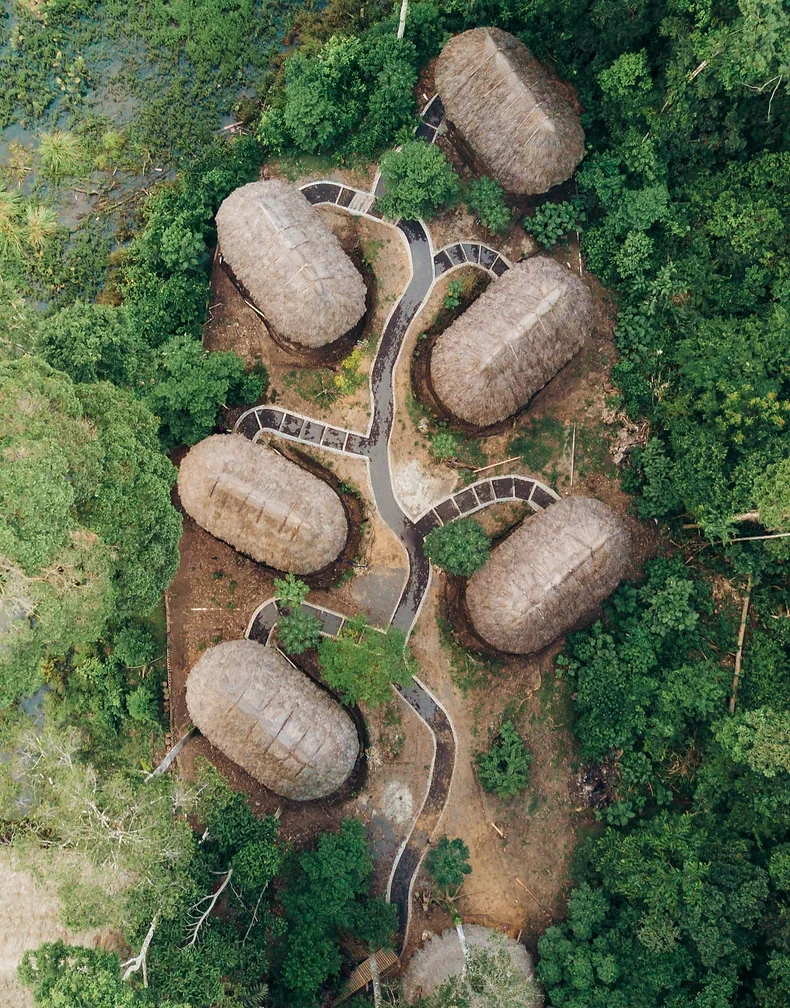 Small straw-bale cottages from above in a forest