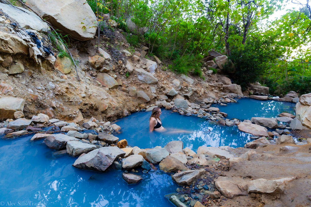 Vibrant blue hot springs in a rocky creek