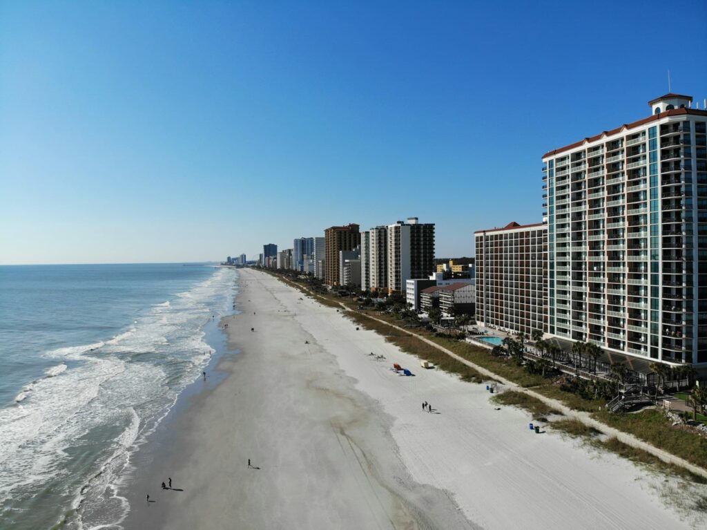 Sandy beach with large multi-storey buildings