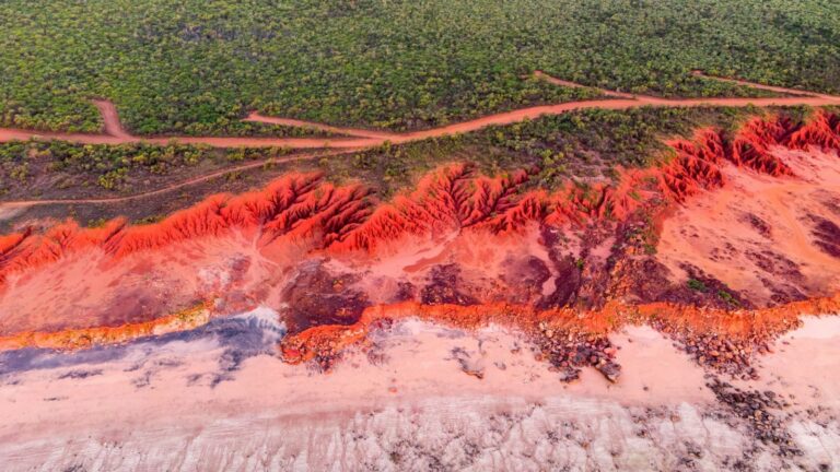 red rocks and reddish pinkish beach