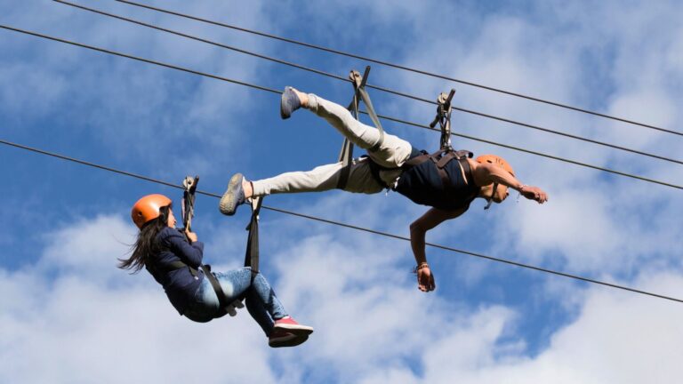 Two people on a zipline