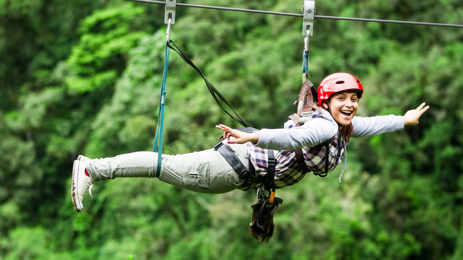 Ziplining woman red helmet