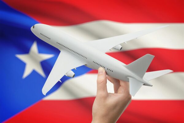 Airplane in front of the flag of Puerto Rico