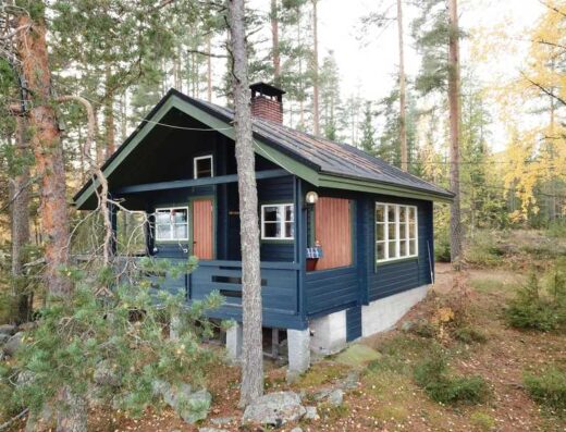 Blue wooden cottage in the forest