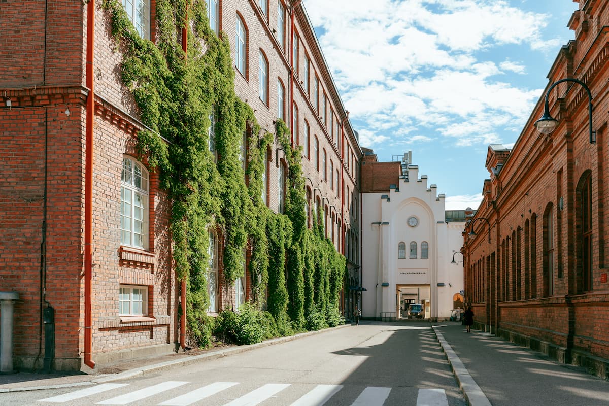 Brick hotel partly covered in ivy on a historic street